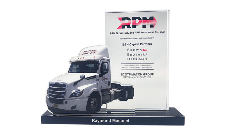 Crystal deal tombstone, featuring a cutout of a semi truck cab, marking a transaction in the transporation and logistics sector.