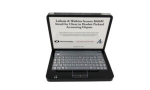 Custom crystal, in the shape of a desktop computer with a keyboard, celebrating a legal award to a technology company.